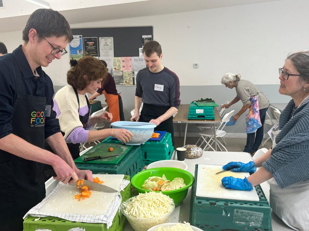 Chris Cornelissen, Graciela Moreno and Chris Bennett food prepping with the team